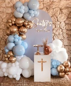 a table topped with balloons and a cross