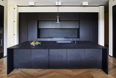 a kitchen with black cabinets and an island