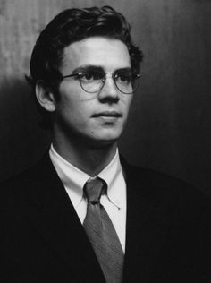 black and white photograph of a man wearing glasses