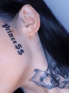 a woman with tattoos on her neck and behind the ear