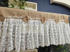 a window curtain with lace and flowers on it