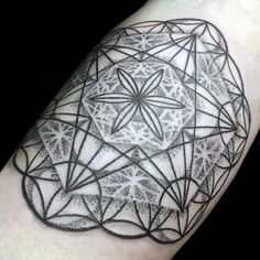 a black and white tattoo design on the arm