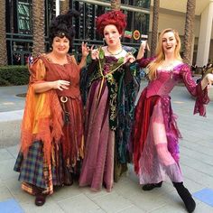 three women dressed in costume posing for the camera