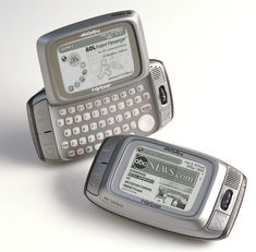 two old cell phones sitting next to each other on a white surface with the same screen