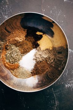 a bowl filled with spices on top of a table