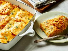 a casserole dish with meat and cheese in it on a plate next to a fork