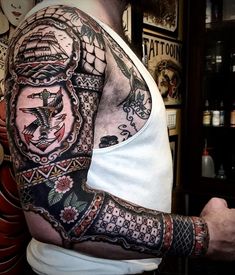 a man with a full sleeve tattoo on his arm