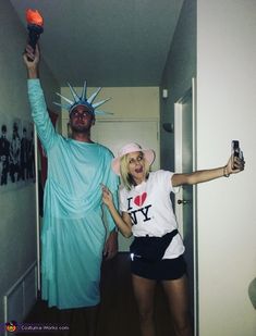 a man and woman dressed up as the statue of liberty, one holding an ice cream cone