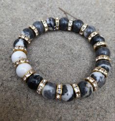 Made with 10 mm round beads. Black and white zebra coloured Jasper stone, with gold  or silver gemstones Bracelets are measured at 16 cm wrist size made with Stretch cord, which won't break easily. Zebra Jasper balances the yin-yang masculine and feminine energies.  It grounds, motivates, calms, helps turn dreams into reality. Reduces overthinking and allows you to connect to the Earth.  Please note, bead colour may be slightly darker/lighter, due to lighting resolutions on different monitor scr Beads Black And White, Gemstones Bracelets, Zebra Jasper, Bracelets Design, Gems Bracelet, Diy Bracelets Patterns, Jewelry Care Instructions, White Zebra, Jasper Stone