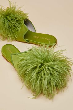 The Contessa Niko is a playfully elegant riff on the indoor slipper, spun into this season's most daring icon in summer bright silk. Handcrafted in a second-generation family-run factory in Tuscany, the Contessa Niko features hand-stitched ostrich feather pom-poms and pairs perfectly with the Casablanca Casca. Product Details Luxury Lime silk slipper with Lime Ostrich feather pom-pom detail Designed in London and made exclusively for Olivia von Halle in Italy Silk slipper with leather upper\/sole, recycled PU heel Sizes: 37-42 Product Code SL0010 Materials and Care Silk slipper with leather upper\/sole, recycled PU heel\n Avoid scratching or rubbing of any kind to preserve the threads\n AVAILABLE SAME DAY WITH OvH CONCIERGE For London zones 1-4 we are pleased to offer complimentary same-da Feather Slippers, Green Slippers, Olivia Von Halle, Loungewear Fashion, Silk Pajama Set, Embroidered Monogram, Ostrich Feather, Pu Heels, Gold Silk