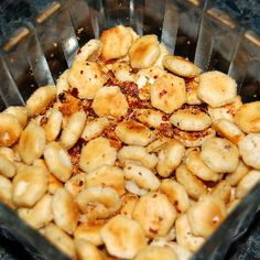 a glass dish filled with cashews sitting on top of a counter