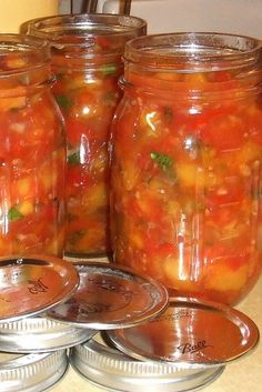 several jars filled with food sitting on top of a counter