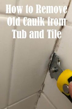 a person using a tool to remove old caulk from tub and tile