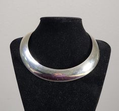 Here is an amazing Ove Wendt designed choker for the Danish silversmith Georg Jensen. Weighing just under 80 grams of sterling silver, this choker has a great feel and the classic look of Danish torques. Total length is just over 13 and 1/4 inches. Classic Silver Choker Jewelry, Silver Polished Choker Jewelry, Classic Sterling Silver Choker, Classic Sterling Silver Choker Jewelry, Formal Polished Choker Jewelry, Silver Polished Choker Necklace, Vintage Sterling Silver Choker In Silver, Modern Polished Choker Jewelry, Georg Jensen Silver