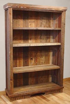 an old wooden bookcase sitting on top of a hard wood floor