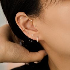 a close up of a person with ear piercings