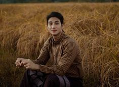 a man sitting in the middle of a field