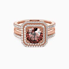 a pink diamond ring with two rows of diamonds around the band and an oval shaped center stone