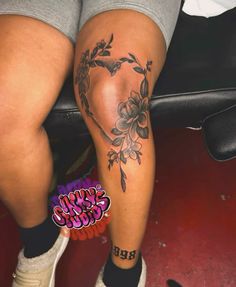 a woman's legs with flowers on them and the word love written in black ink