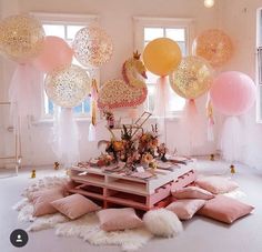 a room with balloons and decorations on the floor