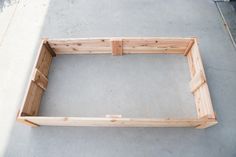 a wooden frame sitting on top of cement