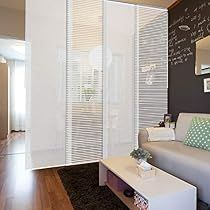 a living room filled with furniture and a chalkboard on the wall behind it's glass doors