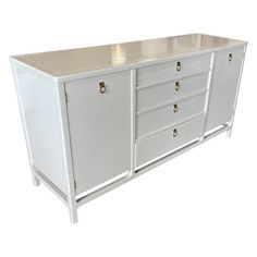 a large white cabinet with drawers and knobs on the doors is against a white background