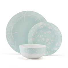 three plates and two bowls with starfish designs on them, one is light green