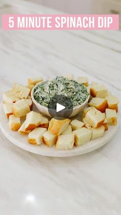 a white plate topped with bread and spinach dip