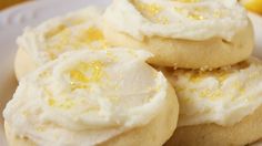 lemon cookies with white frosting on a plate