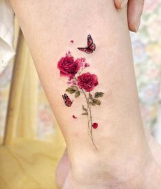 a woman's foot with flowers and butterflies on it