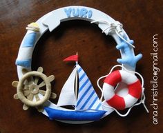 a close up of a toy sailboat and life preserver on a wooden table