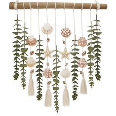 a wind chime hanging from a wooden stick with shells and leaves on the top