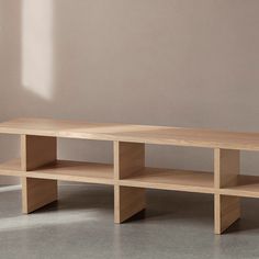 a wooden shelf sitting on top of a cement floor