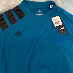 Adidas Teal X-Large Short Sleeve Jersey Like Shirt With Tags. Never Worn Adidas Blue Long Sleeve Tops, Blue Adidas Long Sleeve Tops, Adidas Blue Sporty Shirt, Sporty Adidas Blue Shirt, Adidas Blue Crew Neck Top, Blue Adidas Crew Neck Top, Adidas Blue Tops For Spring, Spring Adidas Blue Tops, Spring Blue Adidas Tops