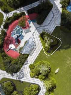 an aerial view of a park with many trees and benches in the middle of it