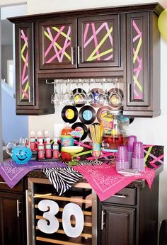 the kitchen is decorated in pink and black