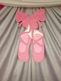 a pair of pink shoes sitting on top of a bed