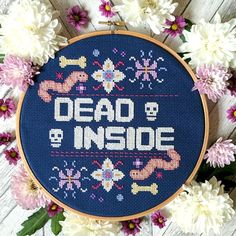 a cross stitch pattern with the words dead & inside on it and flowers around it