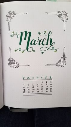 an open notebook with the word march written in green ink on it, sitting on someone's lap