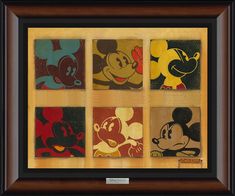 four mickey mouse paintings in a wooden frame