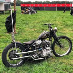 a motorcycle parked on top of a lush green field