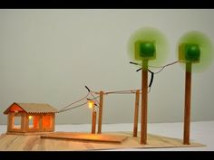 three green lights are on top of a wooden structure with a small house in the middle