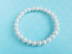 Genuine cultured freshwater pearl bracelet,bridesmaid gift Pearl size:7-8mm pearl shape:near round Color: creamy white Pearl luster: Good Pearl nacre: very thick Elastic pearl bracelet This is a perfect gift for birthday , wedding... in the very attractive price. Please let me know what you want to say on the note card Dear pearl lovers, all pearls in Pearl Select are 100% Real Genuine Cultured freshwater pearls We do not sell faux pearls,imitation pearl,fake pearls,swarovski pearls. Thank you s Pearl White Bracelet With Round Beads For Gifts, White Pearl Drop Bracelets For Bridesmaids, White Pearl Drop Bracelet For Bridesmaids, White Beaded Bracelets With Pearl Charm For Bridesmaids, White Pearl Beaded Bracelet For Bridesmaid Gift, Pearl White Hypoallergenic Pearl Bracelet Gift, Hypoallergenic White Pearl Bracelet For Wedding, Hypoallergenic Pearl White Pearl Bracelet Gift, Hypoallergenic Pearl Bracelet As Gift