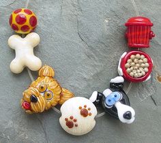 a group of toy dogs on a string with food in the shape of bones and bones