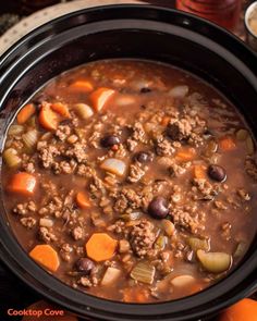 a crock pot filled with meat and vegetables