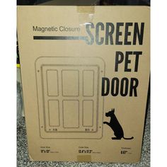 a cardboard box that has a cat sitting in front of the screen pet door on top of it