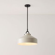 a white light hanging from the ceiling in a room