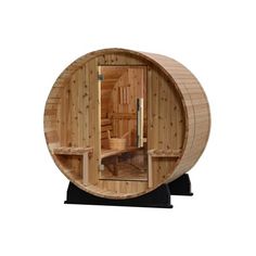 a wooden barrel sauna with the door open