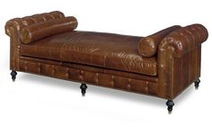 a brown leather chaise lounger on casteors with nailhead feet and arms